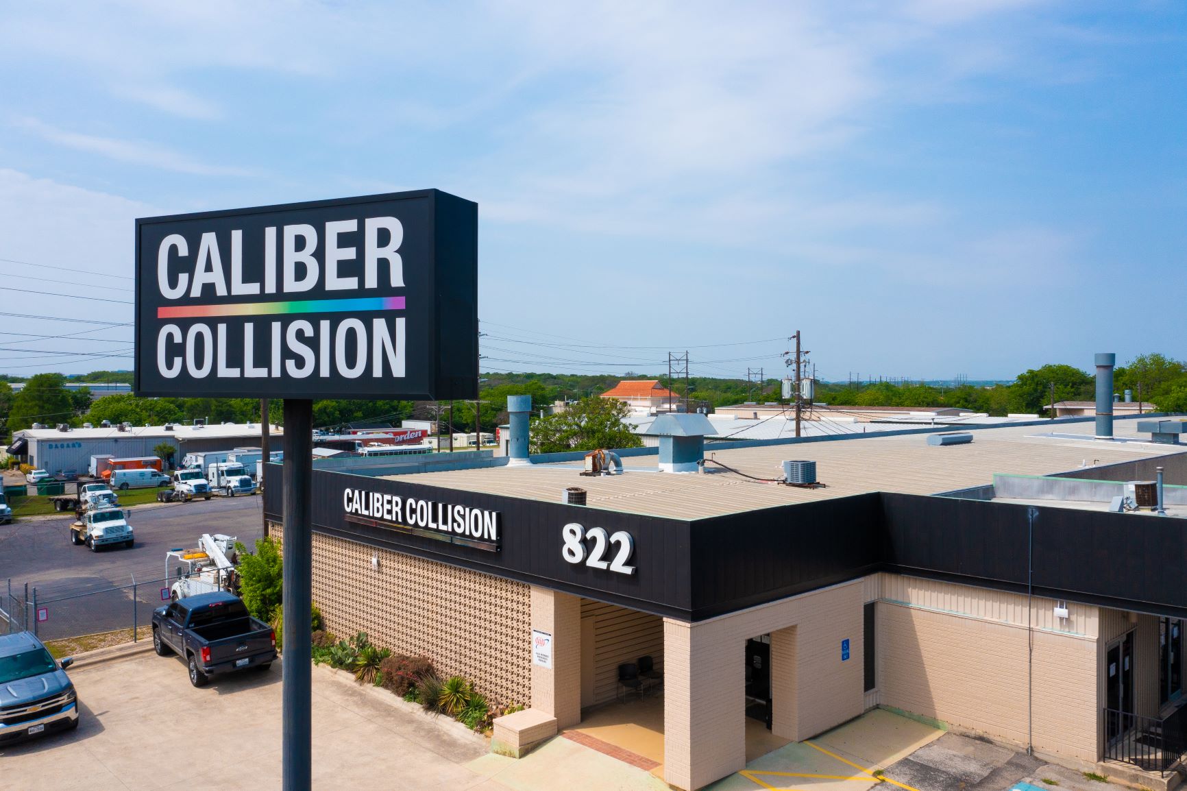 Exterior drone photograph of Caliber Collision building and sign